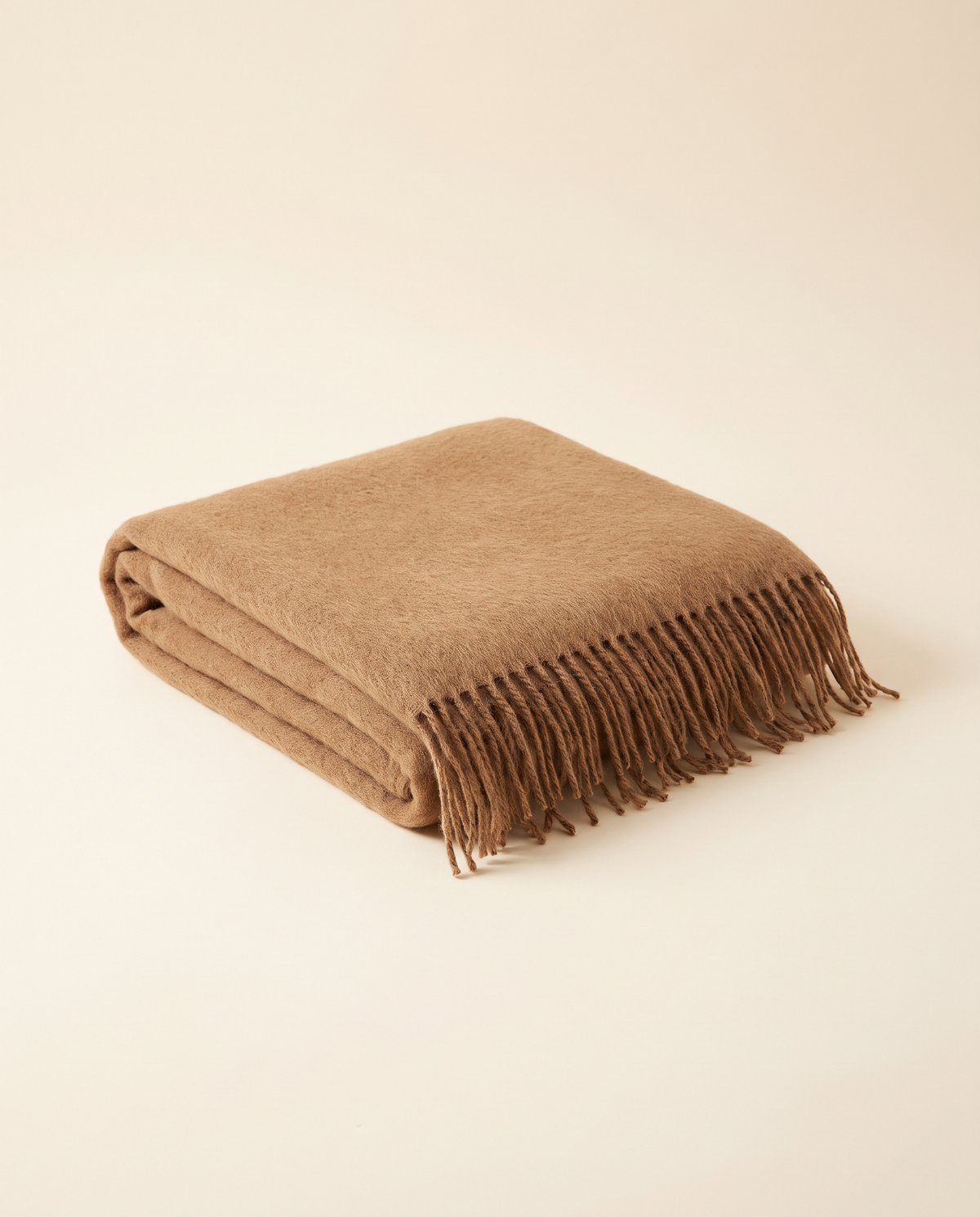 Folded baby alpaca throw in camel
