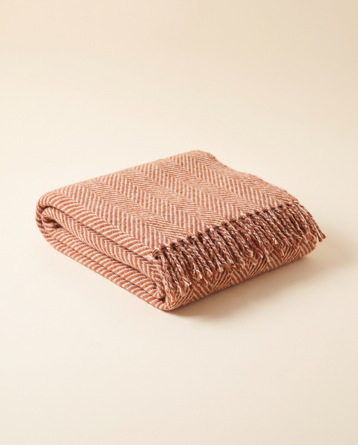 Folded baby alpaca throw in terracotta herringbone