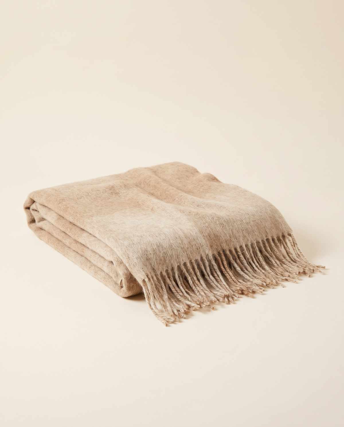 Folded baby alpaca throw in sand