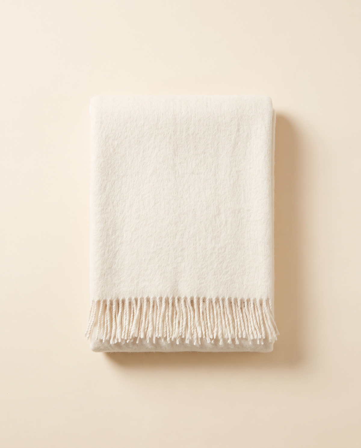 Folded baby alpaca throw in white
