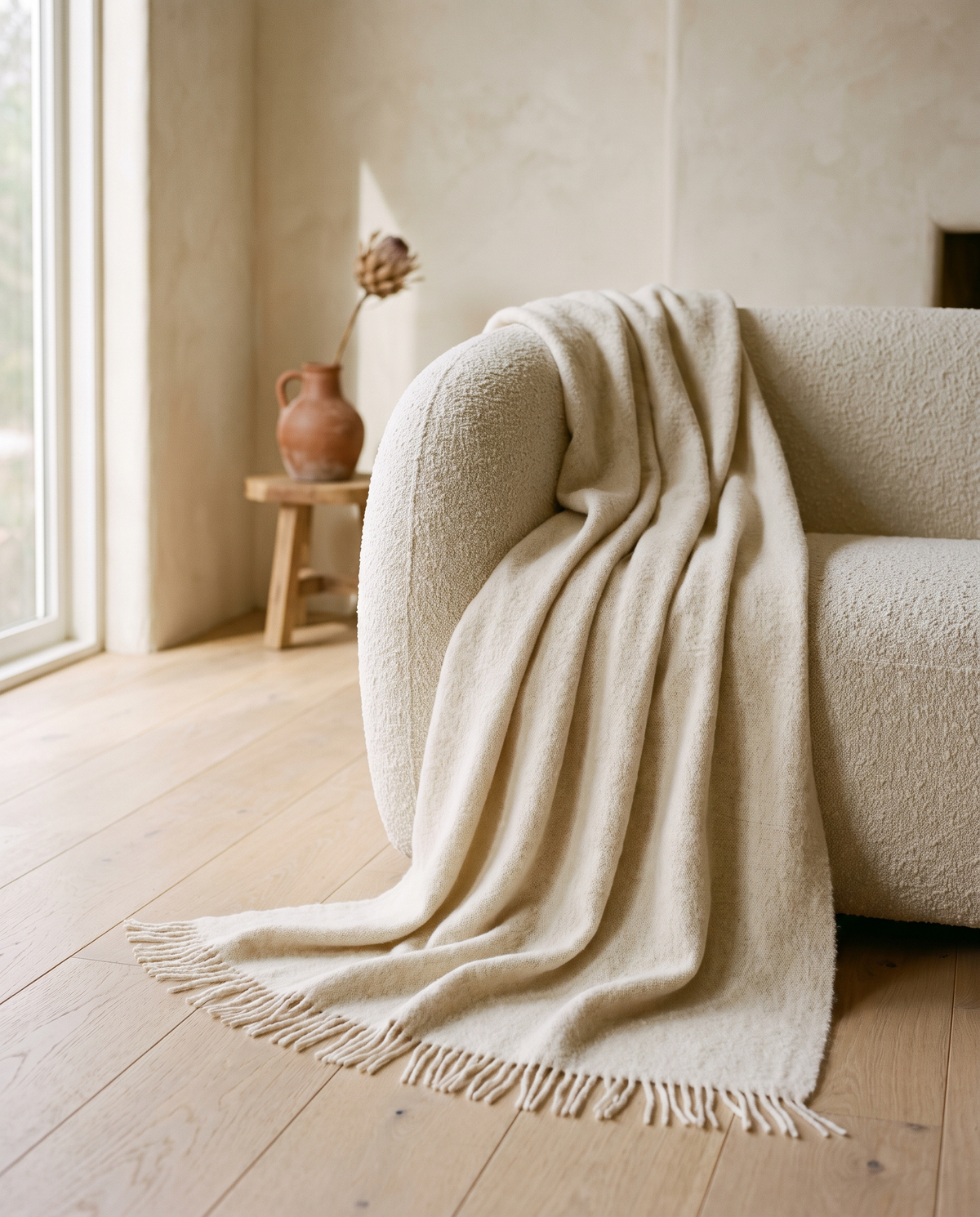 Baby alpaca throw draped over a sofa (concept image)